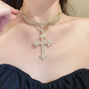 Detailed view of luxury gold multilayer necklace with rhinestone cross pendant