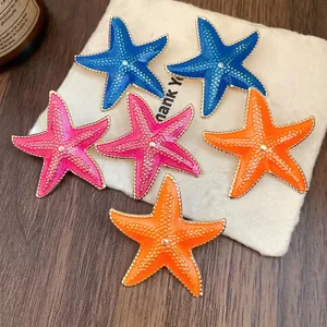 Summer style starfish stud earrings featuring colorful enamel finish and gold trim