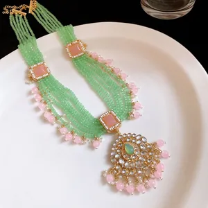Detailed view of a vintage multi-strand green beaded necklace with elegant pink accents.