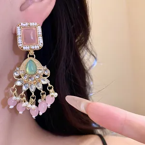 Detail view of elegant vintage geometric resin earrings featuring pink beads and faux pearls