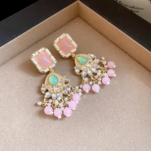 Detailed view of vintage style drop earrings with pink resin and seed pearls