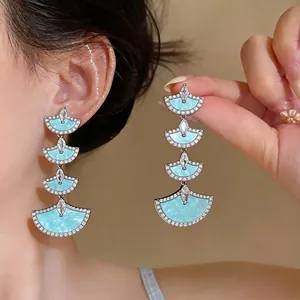 Elegant 18k gold plated fan-shaped dangle earrings with light blue inlay and zircons