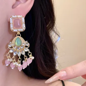 Elegant vintage-style geometric earrings featuring pink resin and green teardrop stone details
