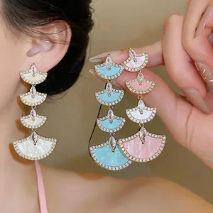 Tiered fan-shaped dangle earrings with sparkling zircons in white, pink, and blue hues