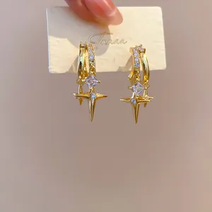 Detailed macro shot of 18k gold plated double layer star clip-on earrings with CZ stones