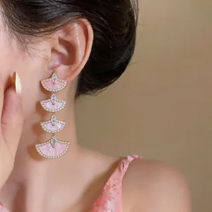 Elegant 18k gold plated long drop earrings featuring fan-shaped segments with pink inlay