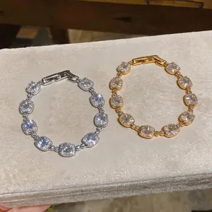 Detailed view of silver and gold plated bracelets with sparkling square cubic zirconia