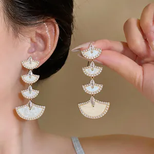Long 18k gold plated fan earrings with sparkling zircon and white shell inlay detail.