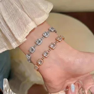 Close-up of 18k gold plated square zircon bracelets on wrist with sparkling halo detail
