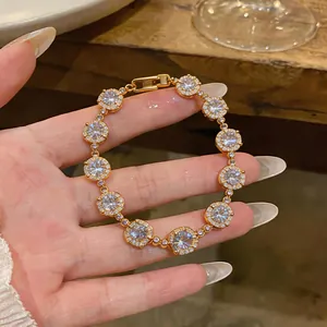 Close-up detail of 18k gold plated bracelet with sparkling zircon stones and square clasp.