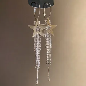 Elegant silver needle drop earrings featuring rhinestone star and sparkling long tassel design