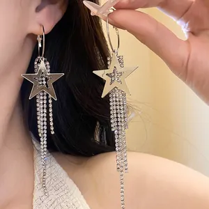 Close-up of sparkling star tassel earrings with rhinestones on an Asian model