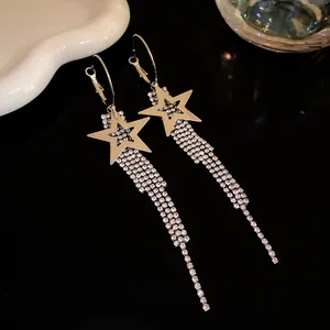 Detailed macro view of silver star earrings featuring sparkling rhinestone long tassels