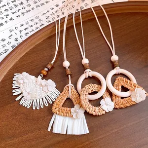 Bohemian long necklace with wooden rings, woven rattan, and delicate flower accents