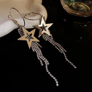 Macro view of elegant silver star earrings featuring sparkling long rhinestone tassels