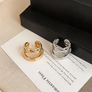 Close-up of French style pleated double-layer ear cuffs in gold and silver finish