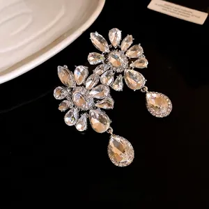 Elegant flower and teardrop pendant clip-on earrings decorated with shimmering crystals