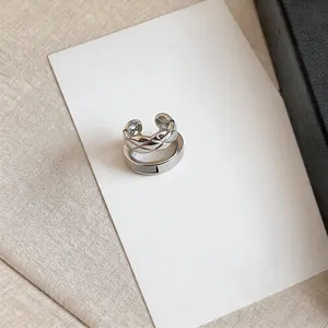 Detail view of silver-toned quilted pattern and plain double-layer ear cuffs for women