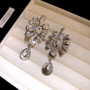 Detailed view of luxury rhinestone flower teardrop clip-on earrings front and back
