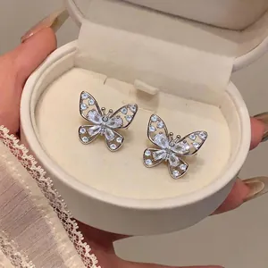 Exquisite hollow butterfly clip-on earrings with sparkling stones in a premium gift box