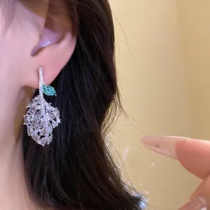 Silver needle zircon openwork leaf drop earrings with sparkling green stone accent