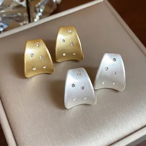 Elegant brushed 18K gold and silver plated stud earrings with sparkling zircons