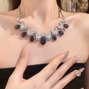 Elegant necklace with purple water drop zircon pendants and pavé stones.