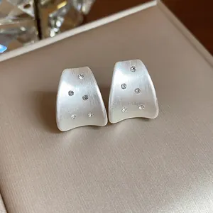 Elegant brushed silver stud earrings with sparkling zircon accents in a gift box.