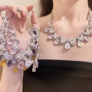 Detailed view of a luxury zircon waterdrop pendant necklace and matching bracelet.