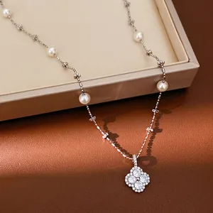 Elegant clover flower pendant necklace featuring white pearls and sparkling zircon stones