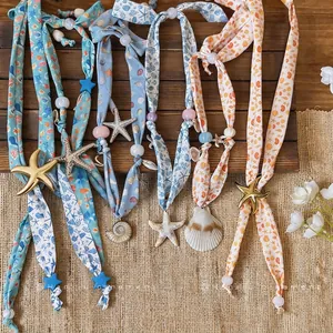 Ocean style printed fabric necklace with starfish and seashell charms for beach vacation