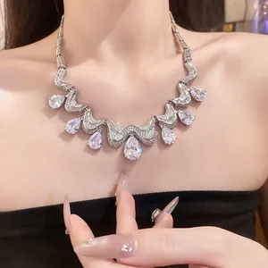 Detailed macro view of a silver choker with sparkling pear-cut zirconia drops