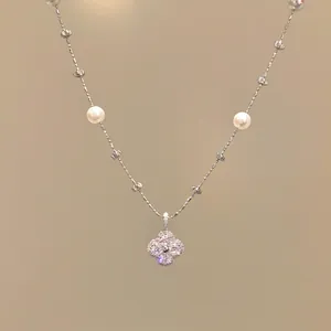 Detailed macro shot of an elegant zircon flower pearl necklace in French chic style