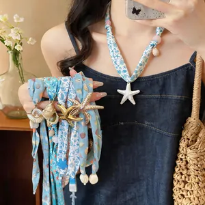 Detail of fabric necklaces with starfish and shell pendants in various beach prints