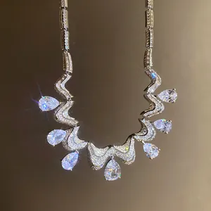 Macro view of luxurious wavy zircon necklace with sparkling pear-shaped pendants