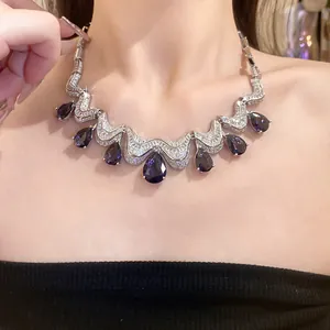 Close-up detail showing luxury teardrop amethyst zircon necklace on model neckline