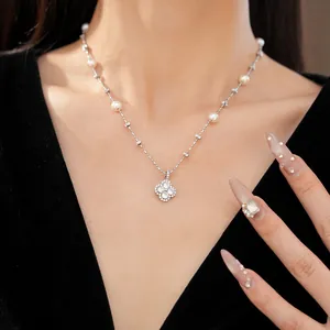 Elegant silver-toned clover flower pendant necklace with pearls and zircons on model