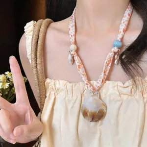Detail view of a Korean style fabric necklace with starfish print and seashell pendant.