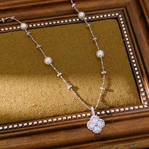 Close-up of refined clover pendant necklace with elegant pearls and sparkling cubic zirconia