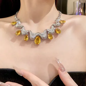 Close-up of luxury necklace with yellow pear-cut zirconia and silver pavé details