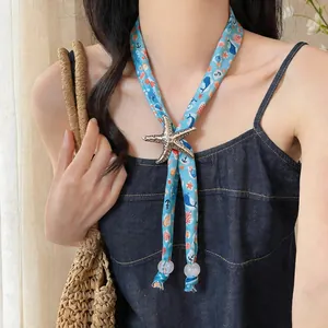 Close-up of a nautical-themed fabric scarf necklace featuring a large starfish charm.