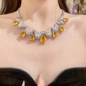 Detailed view of luxury silver-toned necklace with yellow teardrop zircon pendants