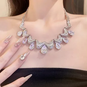 Close-up detail of a silver-toned necklace featuring sparkling teardrop zircon pendants