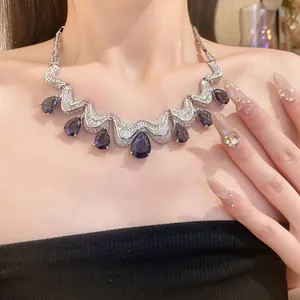 Detailed view of an elegant teardrop purple zircon necklace with silver finish chain