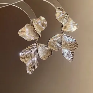 Elegant gold leaf textured drop earrings with a vintage minimalist design for fashion-forward women