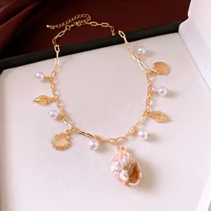 Elegant gold chain necklace with pearls and diverse shell charms for beach vacation