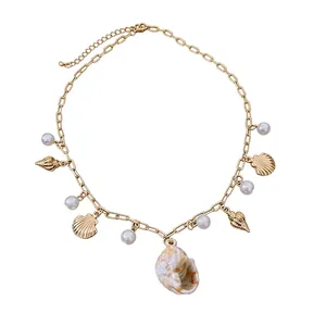 Elegant gold chain necklace with pearl and shell charms for beach vacation fashion styling