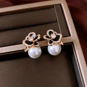 Elegant 14k gold-plated flower stud earrings with white pearl drop detail fashion