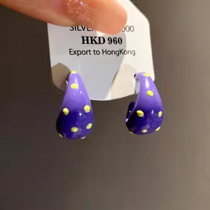 Stylish purple C-shaped drip oil stud earrings with yellow polka dots and silver needles