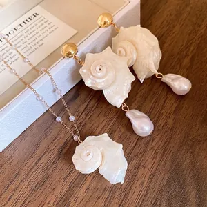 Exquisite gold chain necklace with shell and pearl pendants including matching earrings